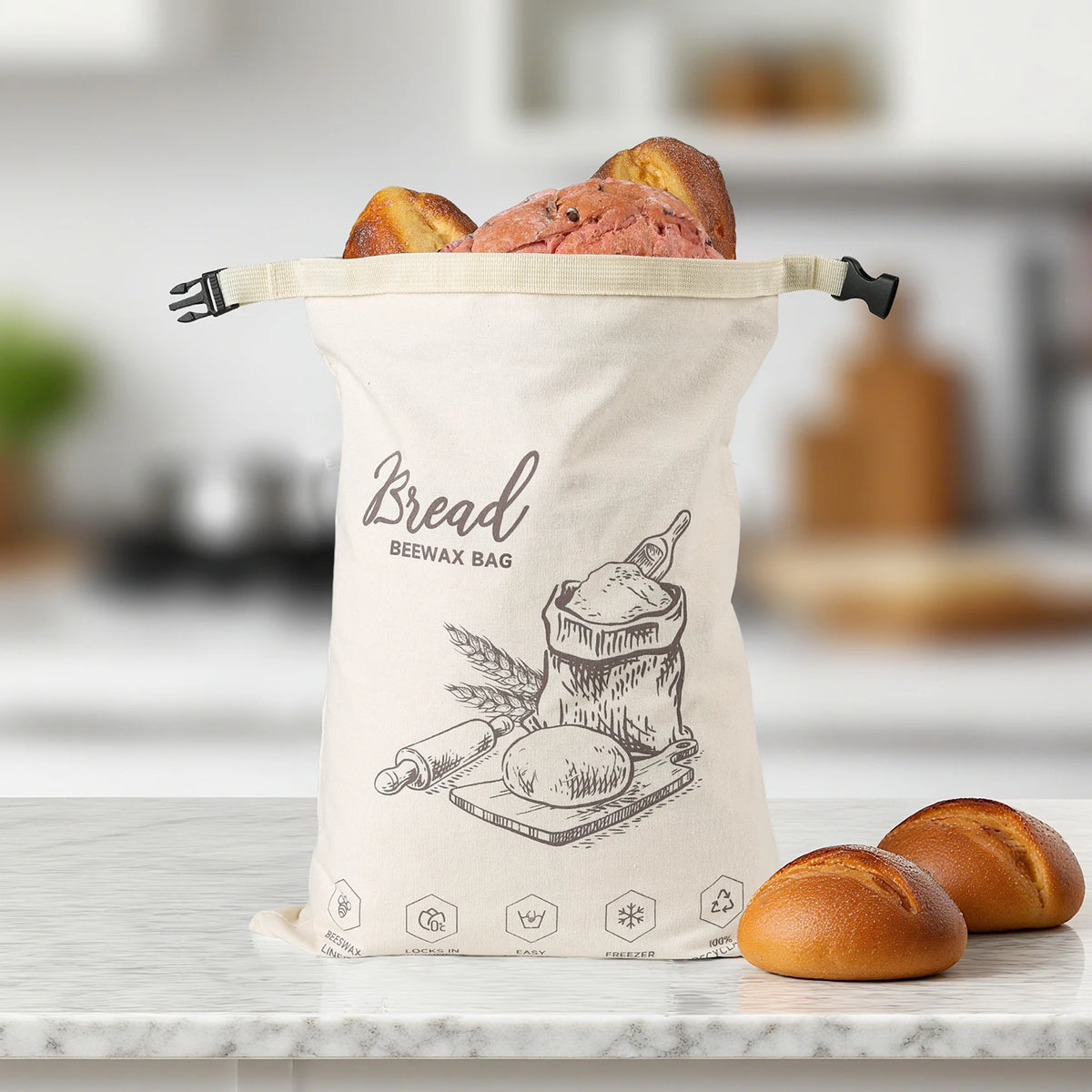 Beeswax-lined cotton bread bag with a sourdough loaf on a kitchen counter